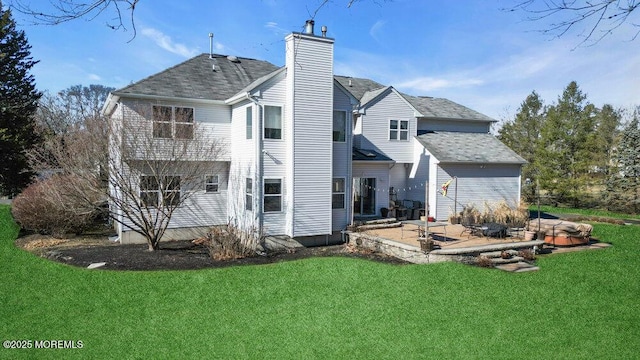 rear view of property with a patio area, a chimney, and a lawn