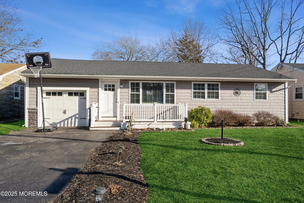 single story home featuring a garage and a front yard