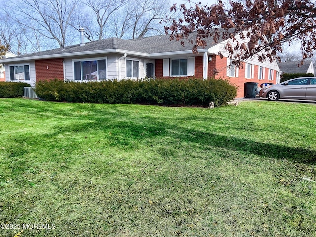 ranch-style house with central AC unit and a front yard