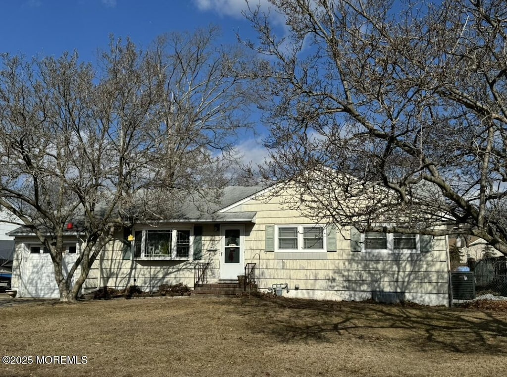 view of front of home with a garage and central AC unit