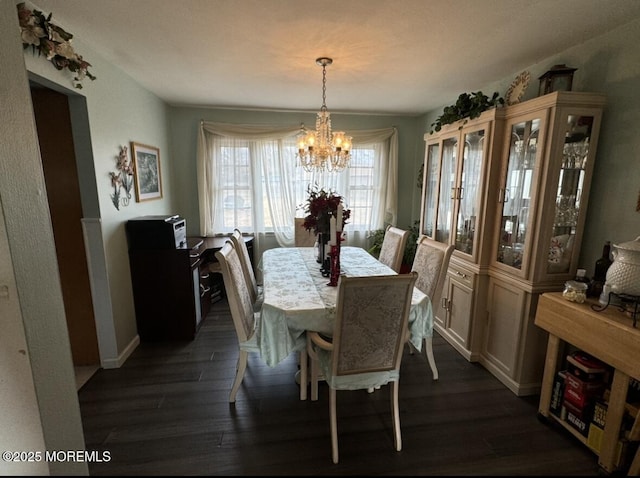 dining area with an inviting chandelier and dark hardwood / wood-style floors