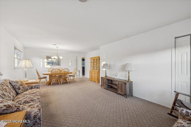 living room featuring an inviting chandelier and carpet flooring