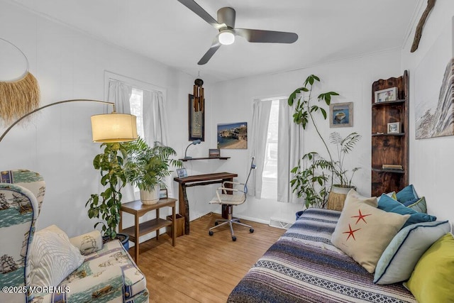 living room with plenty of natural light, hardwood / wood-style floors, and ceiling fan