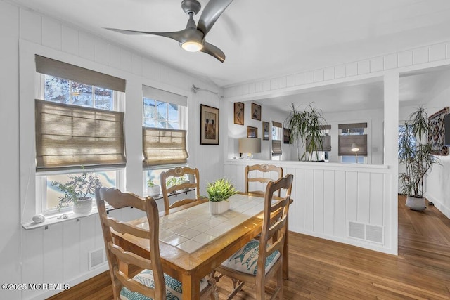 dining space featuring ceiling fan and dark hardwood / wood-style flooring