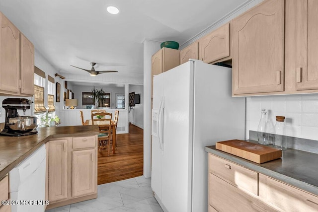 kitchen featuring tasteful backsplash, ceiling fan, light brown cabinets, and white appliances