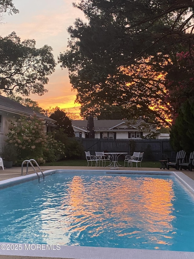 view of pool at dusk