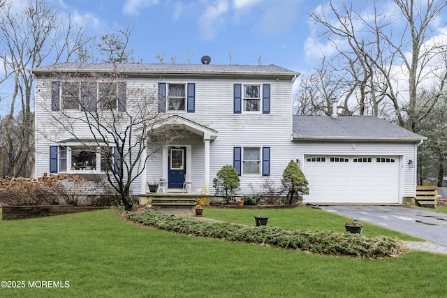 colonial home with a garage and a front lawn