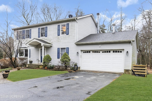 view of front of property featuring a garage and a front lawn