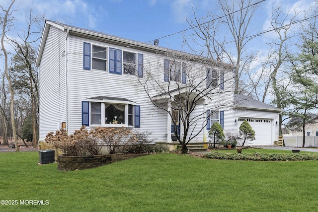 view of front of property with central AC, a garage, and a front lawn