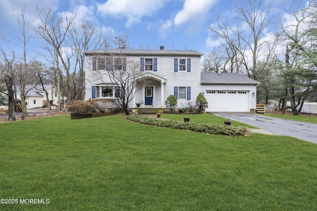 view of front of house featuring a garage and a front yard