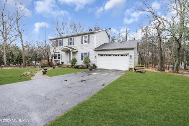 view of front of house with a garage and a front lawn