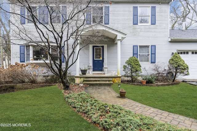 view of front facade with a garage and a front yard