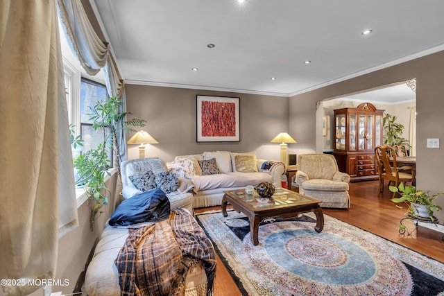 living room with hardwood / wood-style floors and crown molding