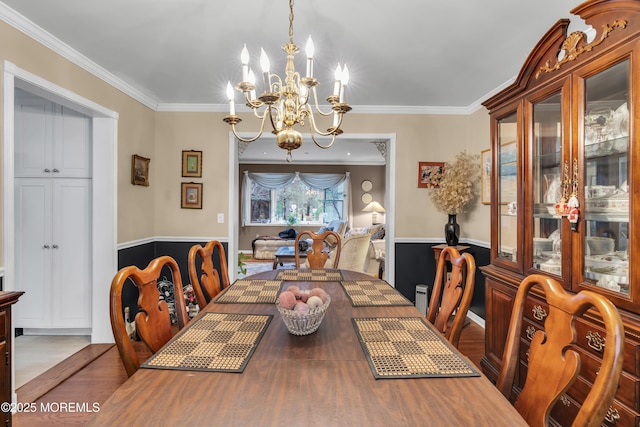 dining area featuring ornamental molding, a chandelier, and wood-type flooring