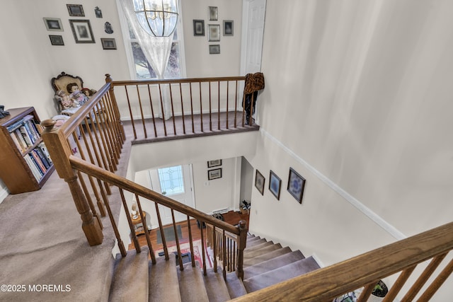 stairway with a chandelier