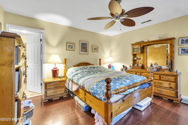 bedroom with dark hardwood / wood-style floors and ceiling fan