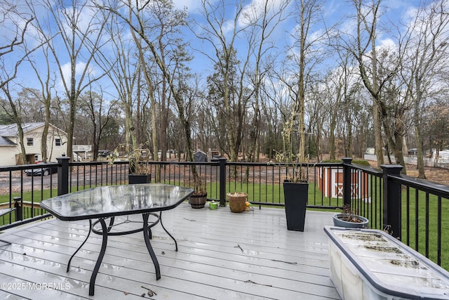 wooden terrace featuring a yard