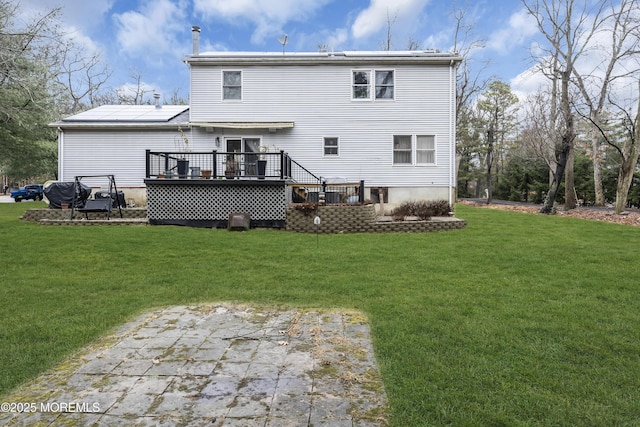 rear view of property with a lawn and a deck