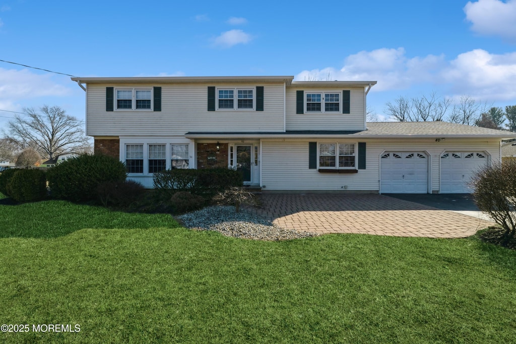 40 Lutea Ter, Freehold, NJ 07728 - traditional-style home featuring an attached garage, a front lawn, and asphalt driveway