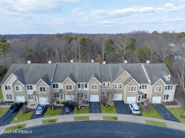 drone / aerial view featuring a view of trees