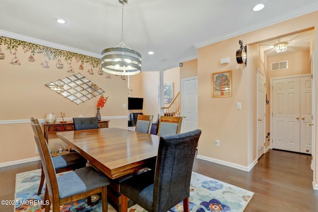 dining area with visible vents, baseboards, ornamental molding, recessed lighting, and wood finished floors