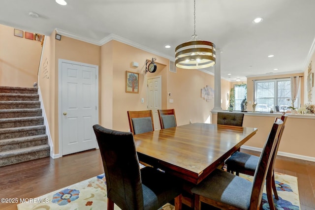 dining space with recessed lighting, ornamental molding, stairs, and wood finished floors