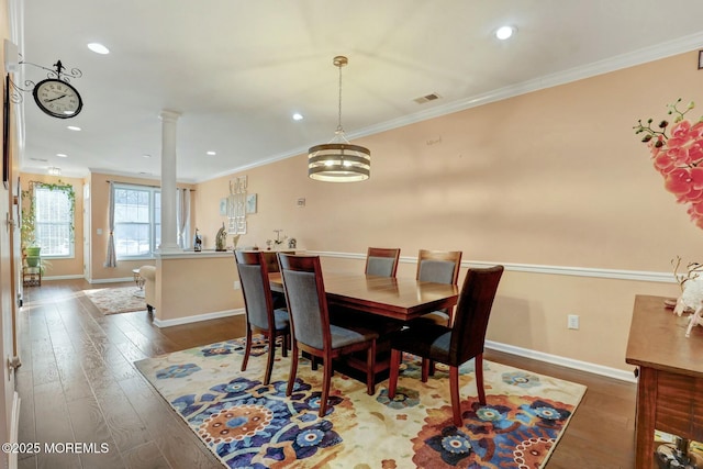 dining area with baseboards, crown molding, dark wood-type flooring, and decorative columns