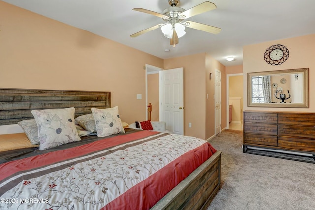 carpeted bedroom featuring baseboards and a ceiling fan