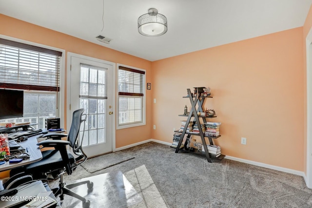 office space featuring visible vents, baseboards, and carpet floors