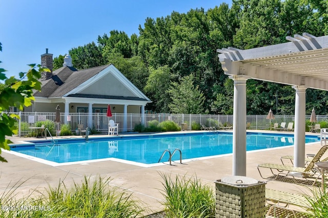 pool with a patio area, fence, and a pergola