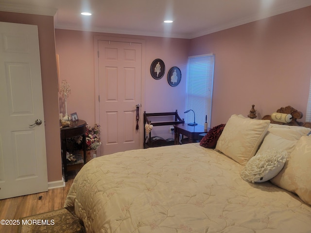 bedroom with hardwood / wood-style floors and crown molding