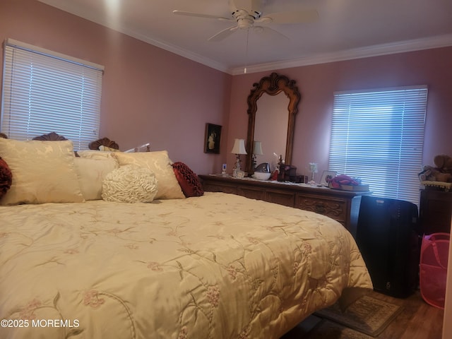 bedroom with hardwood / wood-style flooring, ornamental molding, and ceiling fan