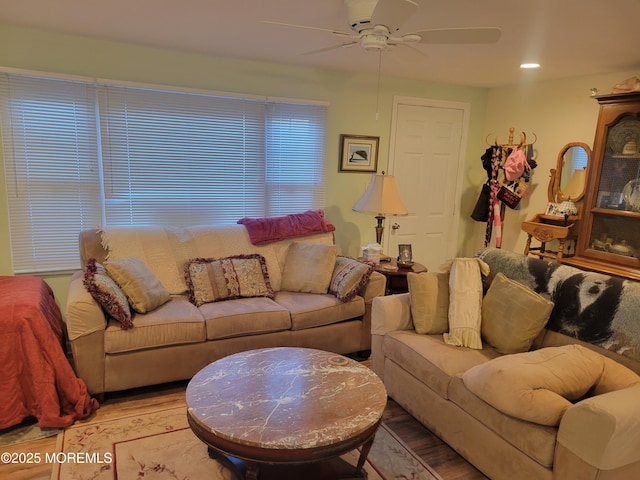 living room featuring ceiling fan and hardwood / wood-style floors