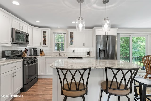 14 Douglas Dr, Jackson, NJ 08527 - kitchen with appliances with stainless steel finishes, plenty of natural light, a kitchen breakfast bar, glass insert cabinets, and recessed lighting