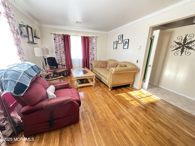 living room featuring hardwood / wood-style flooring and crown molding