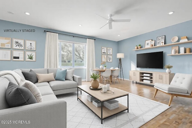 living room featuring ceiling fan and light wood-type flooring