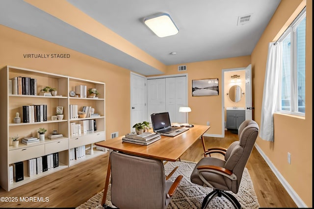 office featuring sink and light wood-type flooring