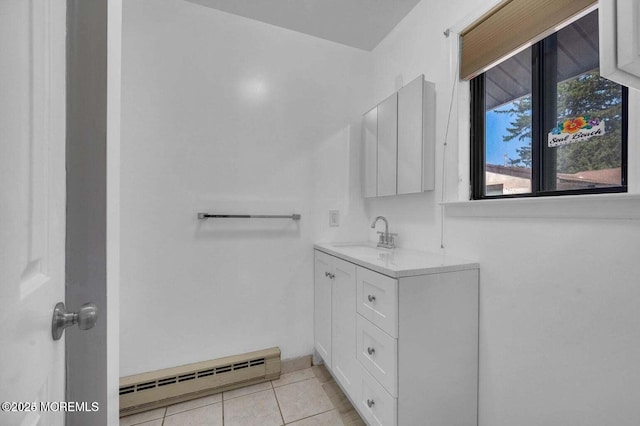 bathroom with tile patterned flooring, baseboard heating, and vanity