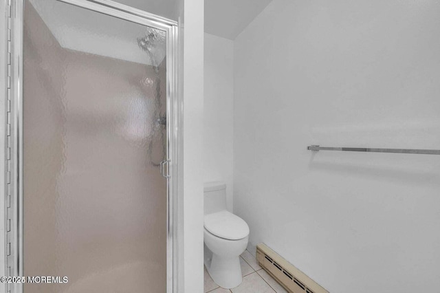 bathroom with a stall shower, tile patterned flooring, and toilet