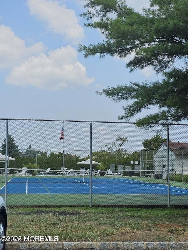 view of sport court featuring fence