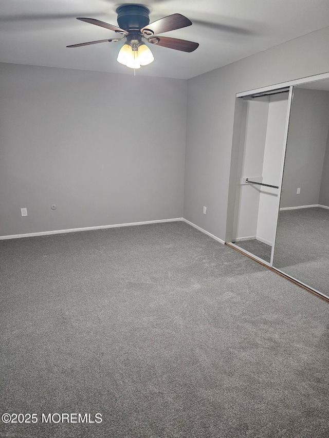 unfurnished bedroom featuring carpet floors, a closet, baseboards, and a ceiling fan