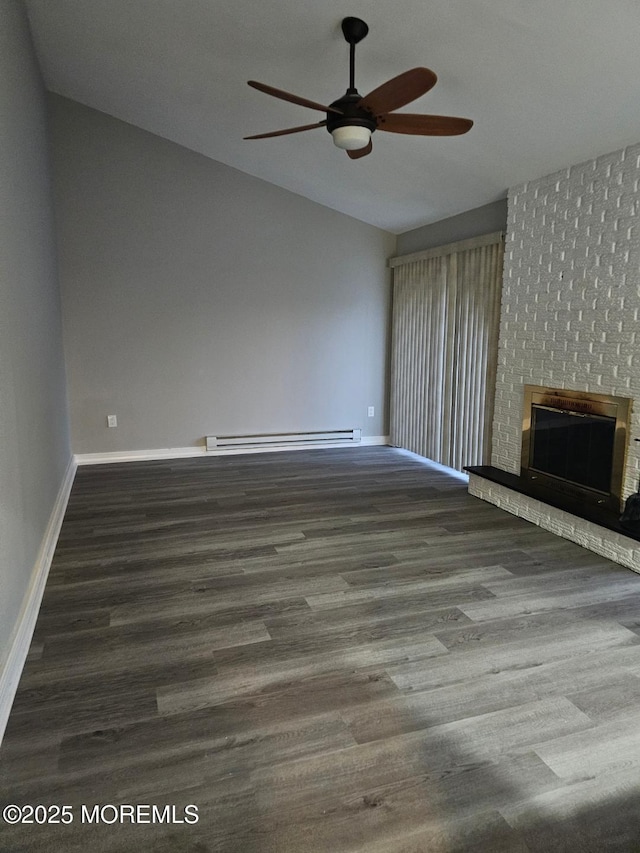 unfurnished living room with a baseboard radiator, a brick fireplace, vaulted ceiling, wood finished floors, and baseboards