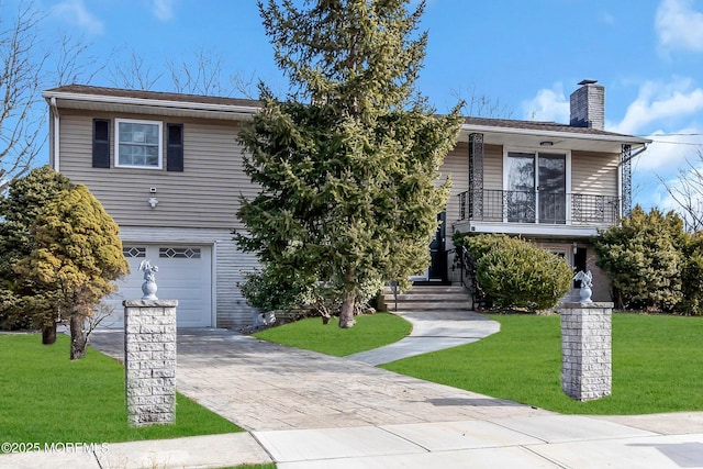 view of front of home featuring a garage, a front lawn, and a balcony