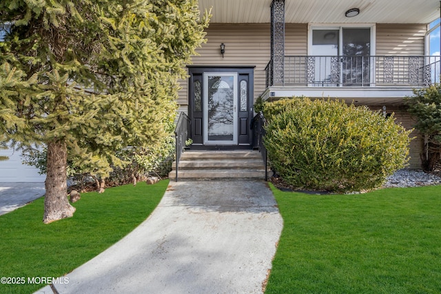 entrance to property featuring a lawn