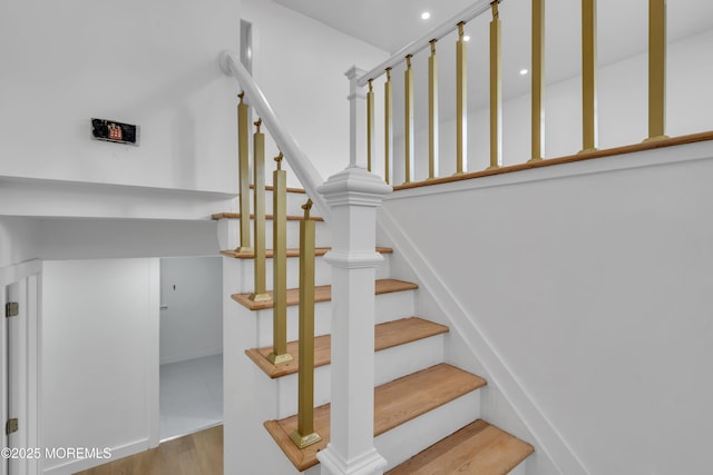 staircase with wood finished floors