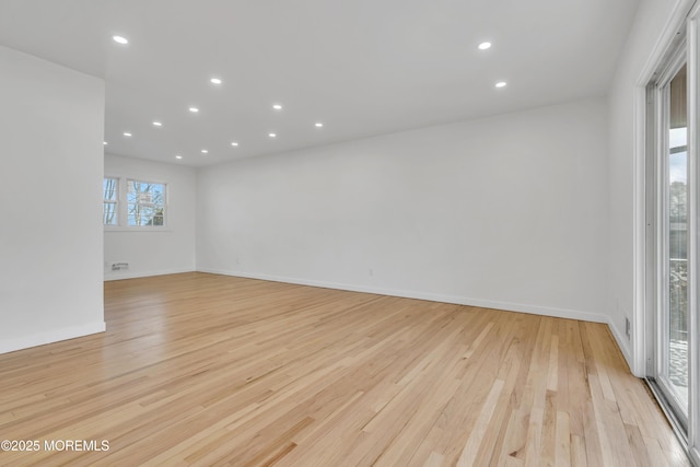 unfurnished room featuring light wood-style floors, baseboards, and recessed lighting