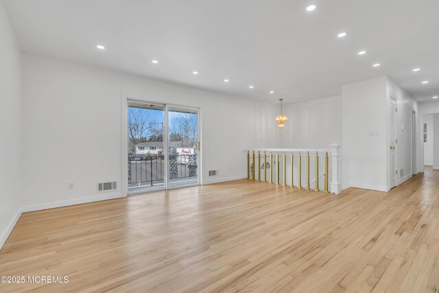 unfurnished room featuring light wood-style flooring, visible vents, baseboards, and recessed lighting