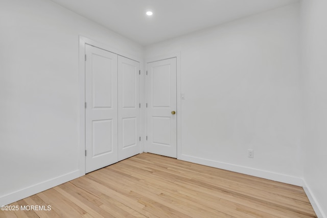 unfurnished room with recessed lighting, light wood-type flooring, and baseboards