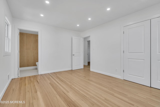 unfurnished bedroom with light wood-type flooring, connected bathroom, baseboards, and recessed lighting