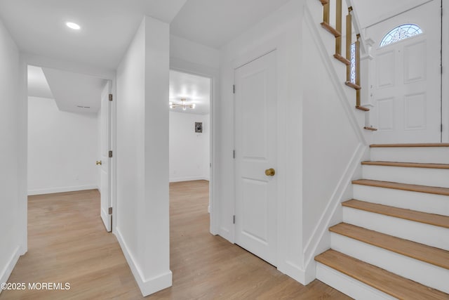 stairway featuring recessed lighting, baseboards, and wood finished floors